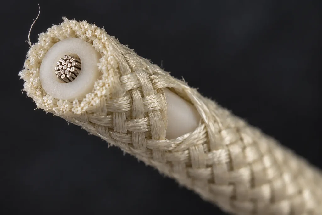 Macro view of UL 3172 wire showing the glass braid fibrous covering over the extruded silicone rubber insulation