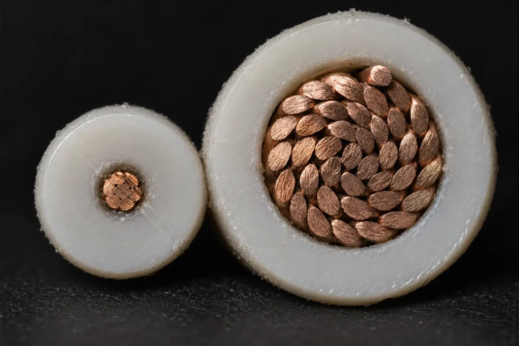 Macro comparison of UL 1015 30 AWG and 8 AWG cut ends showing the different conductor sizes and insulation walls