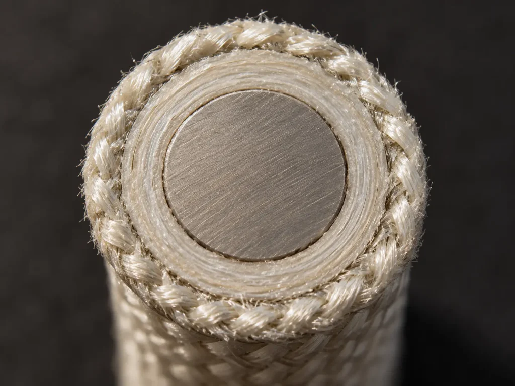Macro cut face of UL 5476 heavy wire with a solid conductor, layered mica tape and treated glass braid