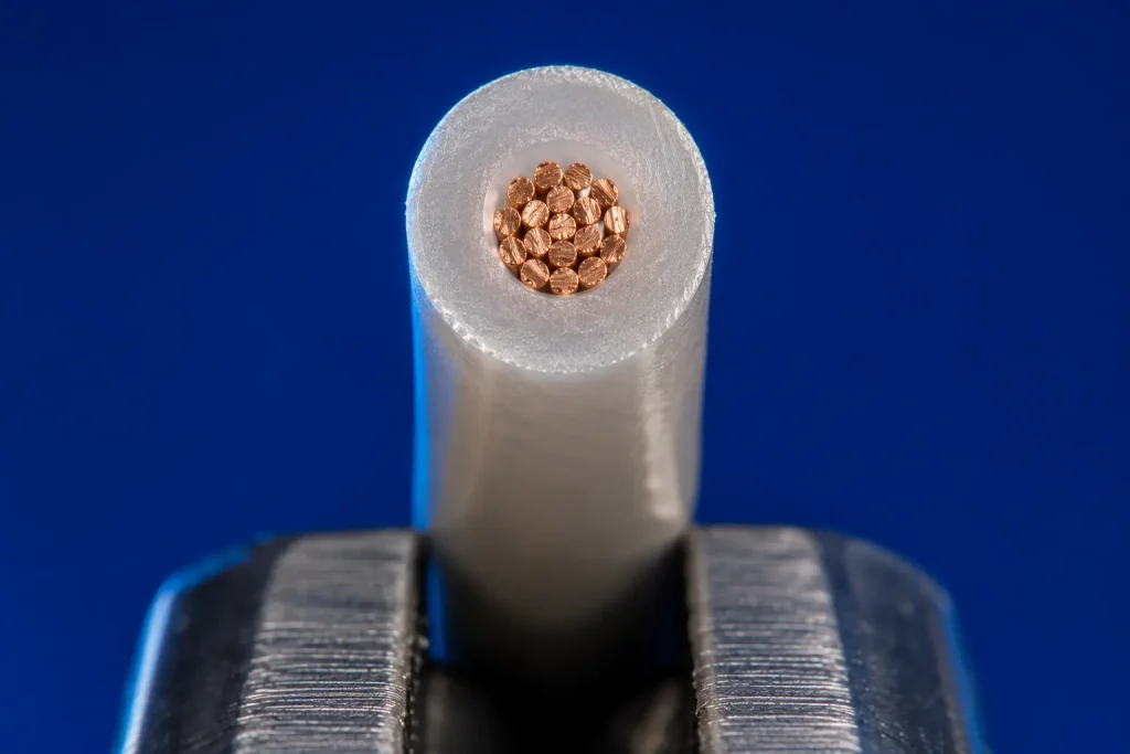 Macro cut end of UL 1330 22 AWG showing FEP insulation 20 mil wall around fine stranded copper conductor