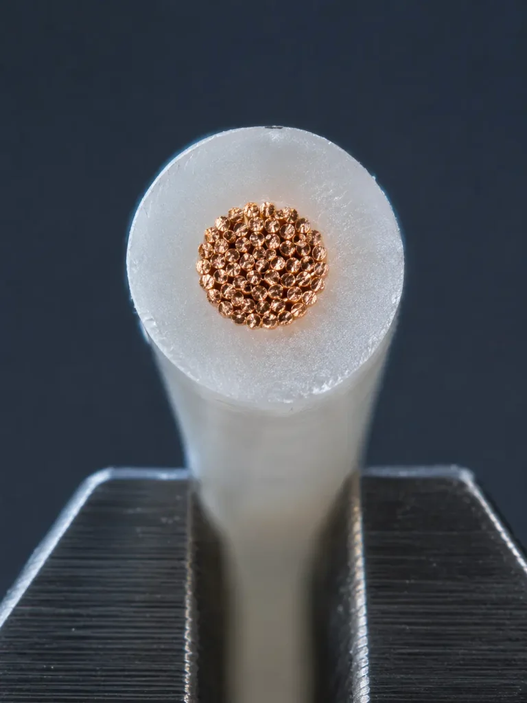 Macro cut end of UL 1333 24 AWG showing generous 13 mil FEP wall proportion around fine copper conductor