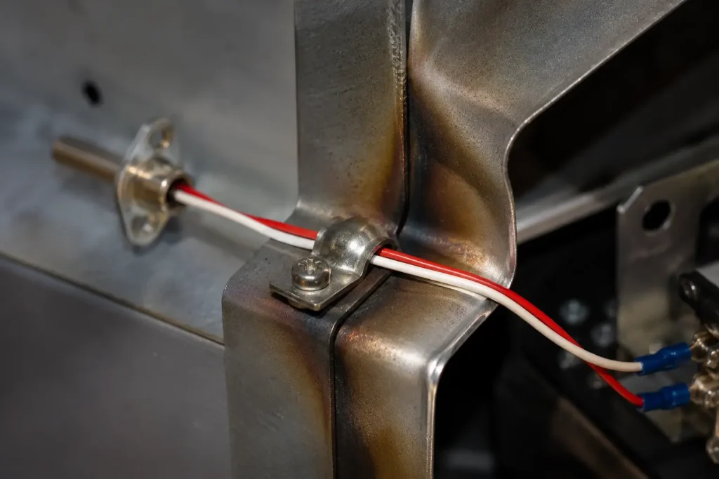 UL 1333 24 AWG FEP sensor lead clamped against bracket inside appliance high temperature compartment
