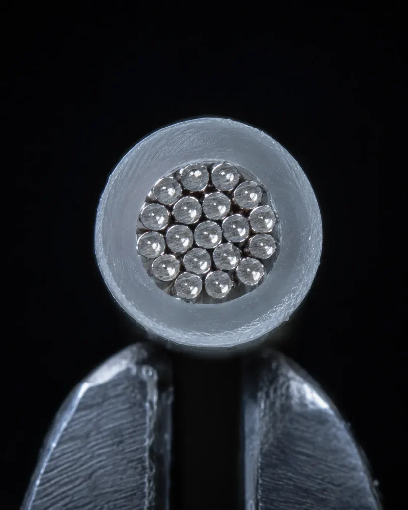 Macro cut end of UL 1591 24 AWG showing 16 mil FEP wall and silver plated stranded copper conductor