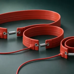 Three red silicone rubber compressor crankcase heater belts, 30 mm wide, coiled with steel tension springs and 1 m power leads, 220 V 43–100 W, -30 to +200°C