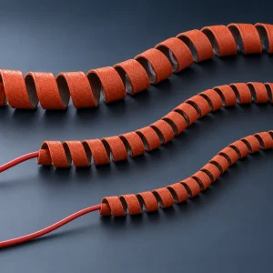 Three pre-formed spiral silicone rubber heating tapes in 6, 8 and 12 mm coil diameters with red power leads, 15–140 W, 12–220 V, -60 to +200°C