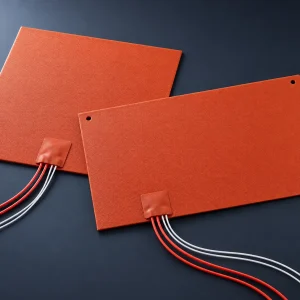 Two custom silicone rubber bed heaters, square and rectangular, with textured orange-red surface, lead exit patch and leads, for 3D printer heated beds